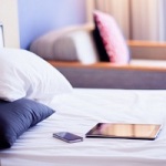 iphone and ipad on bed