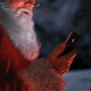Santa Claus listening to Christmas jingles on Phone