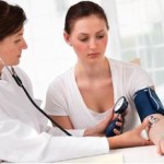 doctor measuring blood pressure from left hand